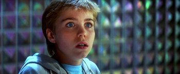 Movie still from “The NeverEnding Story II: The Next Chapter” (1990), directed by George Miller – A young boy looking up into the air; Close Up shot, Low angle