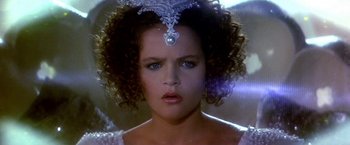 Movie still from “The NeverEnding Story II: The Next Chapter” (1990), directed by George Miller – A person wearing a tiara; Close Up shot, Over the shoulder angle