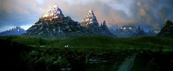 Movie still from “The NeverEnding Story II: The Next Chapter” (1990), directed by George Miller – A painting of a mountain range in the middle of the day; Extreme Wide shot, Low angle