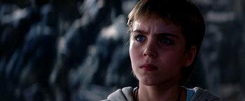 Movie still from “The NeverEnding Story II: The Next Chapter” (1990), directed by George Miller – A person looking at the camera; Close Up shot, Low angle