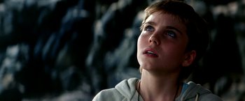 Movie still from “The NeverEnding Story II: The Next Chapter” (1990), directed by George Miller – A young woman looking up into the sky; Close Up shot, Low angle