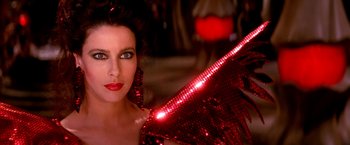 Movie still from “The NeverEnding Story II: The Next Chapter” (1990), directed by George Miller – A beautiful woman with a red sequined umbrella; Close Up shot, Overhead angle