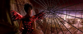 Movie still from “The NeverEnding Story II: The Next Chapter” (1990), directed by George Miller – A woman in a red dress holding an umbrella; Medium shot, Overhead angle