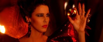 Movie still from “The NeverEnding Story II: The Next Chapter” (1990), directed by George Miller – A beautiful woman in a red dress and red earrings; Close Up shot, Low angle