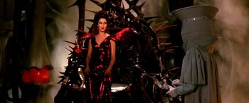 Movie still from “The NeverEnding Story II: The Next Chapter” (1990), directed by George Miller – A woman in a red dress with wings on her shoulders; Medium shot, Overhead angle