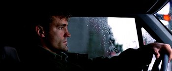 Movie still from “The NeverEnding Story II: The Next Chapter” (1990), directed by George Miller – A person looking out a car window; Close Up shot, Low angle