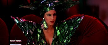 Movie still from “The NeverEnding Story II: The Next Chapter” (1990), directed by George Miller – A woman in a green outfit with a hat on; Close Up shot, Low angle