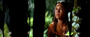 Movie still from “The NeverEnding Story II: The Next Chapter” (1990), directed by George Miller – A young man in a native american outfit; Close Up shot, Low angle