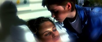 Movie still from “The NeverEnding Story II: The Next Chapter” (1990), directed by George Miller – A woman and a young boy looking at each other; Close Up shot, High angle