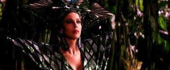 Movie still from “The NeverEnding Story II: The Next Chapter” (1990), directed by George Miller – A woman in a black and silver dress with a black umbrella; Close Up shot, Low angle