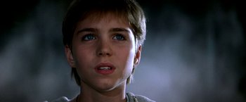 Movie still from “The NeverEnding Story II: The Next Chapter” (1990), directed by George Miller – A young person with blue eyes; Close Up shot, Low angle