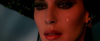 Movie still from “The NeverEnding Story II: The Next Chapter” (1990), directed by George Miller – A woman's face with tears falling down her face; Extreme Close Up shot, Low angle