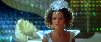 Movie still from “The NeverEnding Story II: The Next Chapter” (1990), directed by George Miller – A person wearing a tiara; Close Up shot, Over the shoulder angle