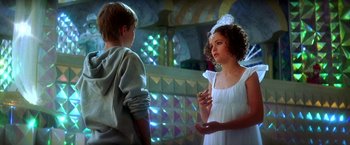 Movie still from “The NeverEnding Story II: The Next Chapter” (1990), directed by George Miller – Two young people standing next to each other; Medium shot, Over the shoulder angle