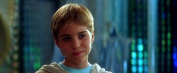 Movie still from “The NeverEnding Story II: The Next Chapter” (1990), directed by George Miller – A boy with blonde hair and blue eyes; Close Up shot, Over the shoulder angle