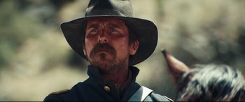 Movie still from “Hostiles” (2017), directed by Scott Cooper – A person wearing a hat; Close Up shot, Low angle