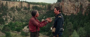 Movie still from “Hostiles” (2017), directed by Scott Cooper – A man and a woman are chained to each other outside; Medium shot, Over the shoulder angle