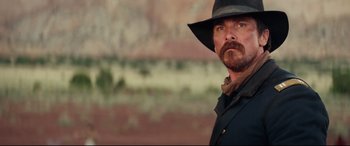 Movie still from “Hostiles” (2017), directed by Scott Cooper – A person wearing a hat; Close Up shot, Over the shoulder angle