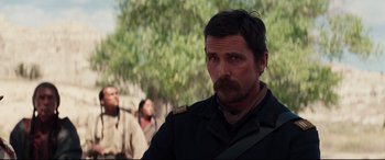 Movie still from “Hostiles” (2017), directed by Scott Cooper – A person with a beard; Close Up shot, Over the shoulder angle