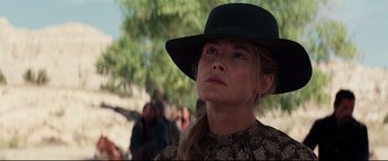Movie still from “Hostiles” (2017), directed by Scott Cooper – A woman wearing a black hat looking to her left; Close Up shot, Low angle