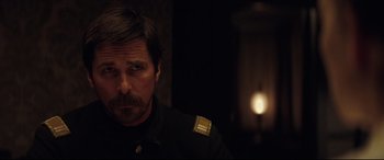 Movie still from “Hostiles” (2017), directed by Scott Cooper – A person wearing a uniform; Close Up shot, Over the shoulder angle