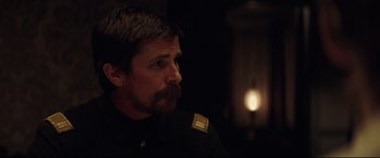 Movie still from “Hostiles” (2017), directed by Scott Cooper – A person with a beard; Close Up shot, Over the shoulder angle