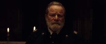 Movie still from “Hostiles” (2017), directed by Scott Cooper – An old man with a beard wearing a military uniform; Close Up shot, Low angle