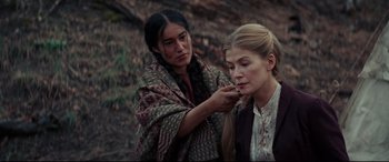 Movie still from “Hostiles” (2017), directed by Scott Cooper – A woman putting makeup on another woman's face; Close Up shot, Over the shoulder angle