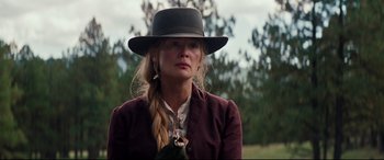 Movie still from “Hostiles” (2017), directed by Scott Cooper – A woman in a hat and a long braid; Close Up shot, Low angle
