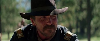 Movie still from “Hostiles” (2017), directed by Scott Cooper – A person wearing a hat; Close Up shot, Low angle