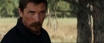 Movie still from “Hostiles” (2017), directed by Scott Cooper – A person with a beard; Close Up shot, Over the shoulder angle