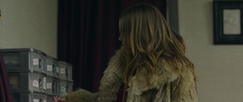 Movie still from “The New Romantic” (2018), directed by Carly Stone – A woman with long brown hair wearing a fur coat; Close Up shot, Over the shoulder angle