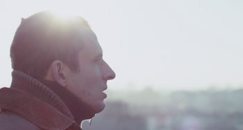 Movie still from “The Night Eats the World” (2018), directed by Dominique Rocher – A person looking out a window; Close Up shot, Low angle