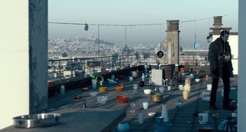 Movie still from “The Night Eats the World” (2018), directed by Dominique Rocher – A view of a city from a roof top; Extreme Wide shot, High angle