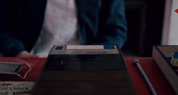 Movie still from “The Night Eats the World” (2018), directed by Dominique Rocher – An old video tape is sitting on a table; Extreme Close Up shot, High angle