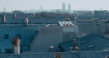 Movie still from “The Night Eats the World” (2018), directed by Dominique Rocher – A view of a bunch of rooftops in a city; Extreme Wide shot, Low angle