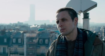 Movie still from “The Night Eats the World” (2018), directed by Dominique Rocher – A person with a city in the background; Close Up shot, Low angle