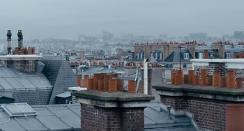 Movie still from “The Night Eats the World” (2018), directed by Dominique Rocher – A view of the rooftops of a large city; Extreme Wide shot, Low angle