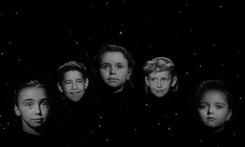Movie still from “The Night of the Hunter” (1955), directed by Charles Laughton – Three young children are posing for a picture; Medium shot, Low angle