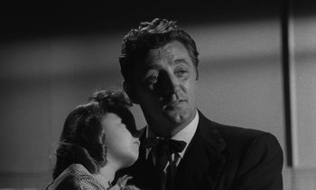 Movie still from “The Night of the Hunter” (1955), directed by Charles Laughton – A black and white photo of a man and a woman; Close Up shot, Low angle