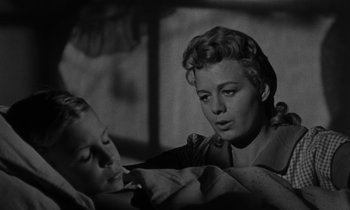 Movie still from “The Night of the Hunter” (1955), directed by Charles Laughton – Two women are looking at each other in a black and white photo; Close Up shot, Low angle