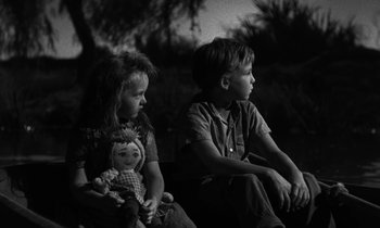 Movie still from “The Night of the Hunter” (1955), directed by Charles Laughton – A boy and a girl sitting next to each other; Medium shot, Over the shoulder angle