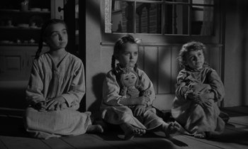 Movie still from “The Night of the Hunter” (1955), directed by Charles Laughton – A group of children sitting in front of a window; Medium shot, Low angle
