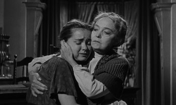 Movie still from “The Night of the Hunter” (1955), directed by Charles Laughton – Two women are hugging and one of them is crying; Medium shot, Low angle