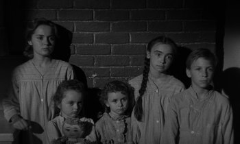 Movie still from “The Night of the Hunter” (1955), directed by Charles Laughton – A black and white photo of a group of children; Medium shot, High angle