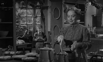 Movie still from “The Night of the Hunter” (1955), directed by Charles Laughton – A man and a woman in a room with dishes; Medium shot, Over the shoulder angle