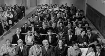 Movie still from “The Night of the Iguana” (1964), directed by John Huston – A group of people sitting in a room; Wide shot, High angle