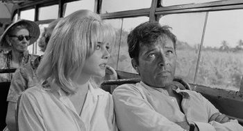 Movie still from “The Night of the Iguana” (1964), directed by John Huston – A man and a woman sitting next to each other on a bus; Close Up shot, Low angle