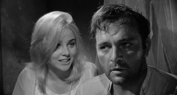 Movie still from “The Night of the Iguana” (1964), directed by John Huston – A man and a woman posing for a picture; Close Up shot, Over the shoulder angle