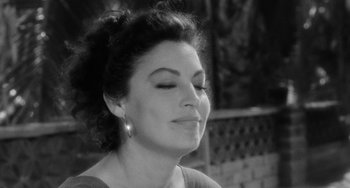 Movie still from “The Night of the Iguana” (1964), directed by John Huston – Black and white photograph of a woman with closed eyes; Close Up shot, High angle
